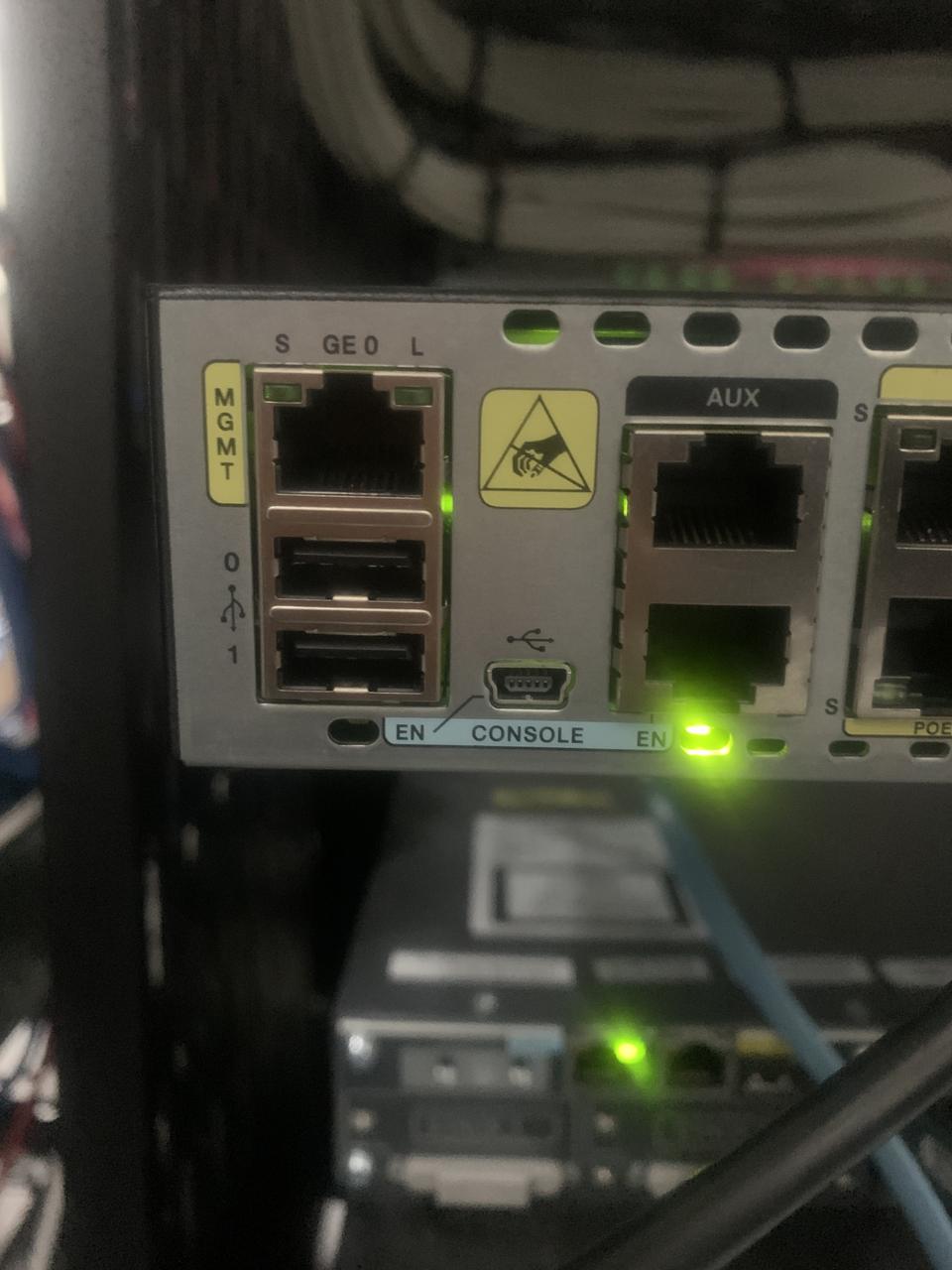 Close-up of a router console and management ports with a green status light