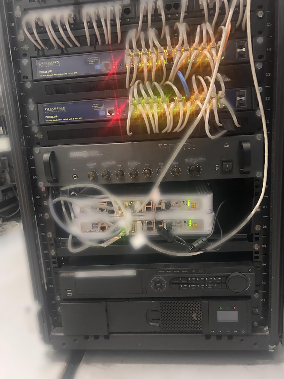 Floor-standing office comms rack with patch panels, switches and equipment