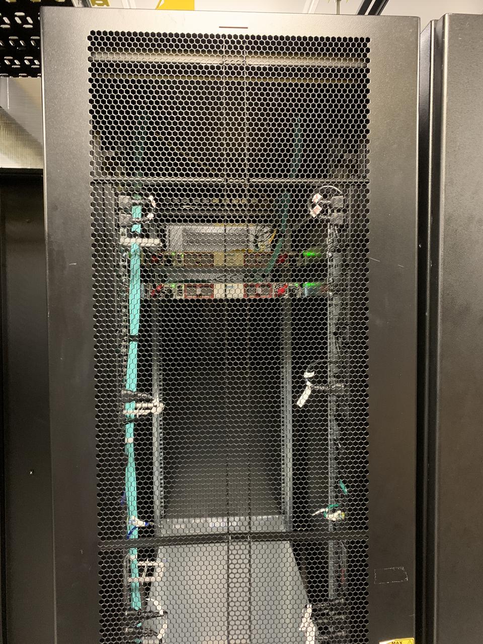 Open rack cabinet with aqua fibre routed down both sides