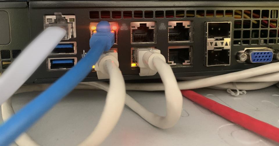Blue and grey patch leads plugged into router ports
