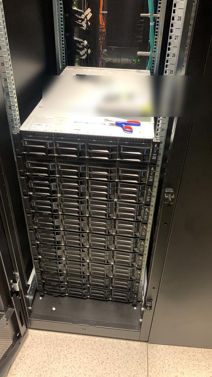 High-density server chassis mounted in a rack, asset label blurred