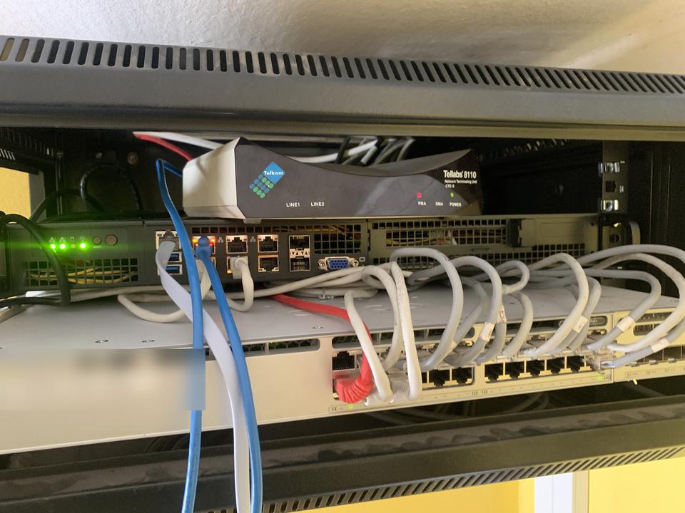 Switch and patch panel in a comms cabinet